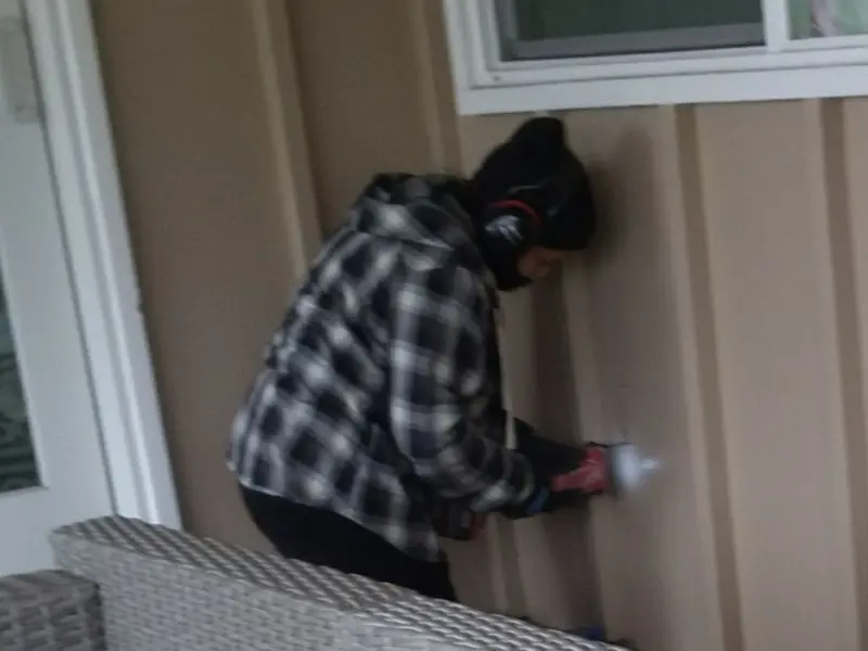 Professional electrician installing an exterior outlet in Larned